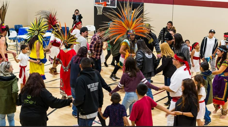 A group of people dancing in the Globeville Recreation Center