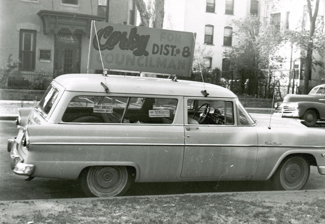 Station wagon with sign "Corky for Councilman-District 8"
