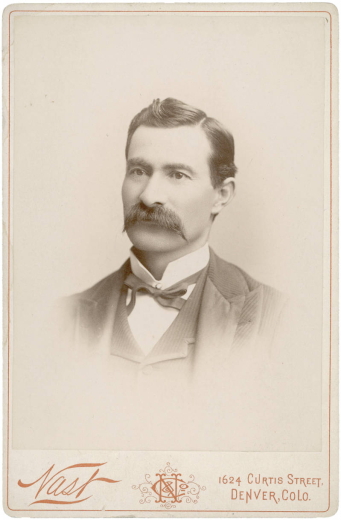 Studio portrait of Colorado State Senator (Las Animas County) Casimiro Barela. He wears a vest and jacket, a bow tie and an upright collar. He has a full, waxed mustache and his dark hair has a cowlick and is parted on the side.