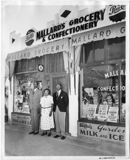 David and Virgina Mallard with man in front of Mallard's Grocery & Confectionery.