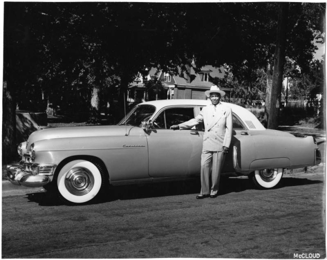 Otha Rice standing by Cadillac.