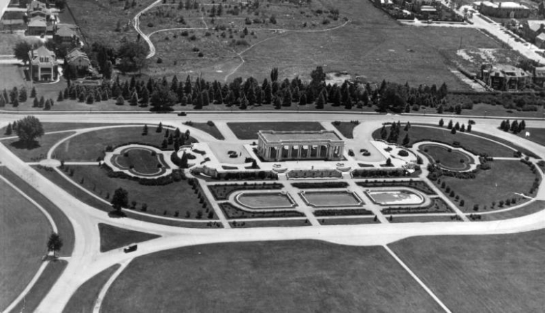Aerial view of the Cheesman Memorial Pavilion, completed in 1910, and Cheesman Park, in the Capitol Hill neighborhood of Denver, Colorado. The pavilion is supported by columns and surrounded by gardens and fountains. Shows the abandoned Mount Cavalry Cemetery the Catholic section of Mount Prospect (City Cemetery).