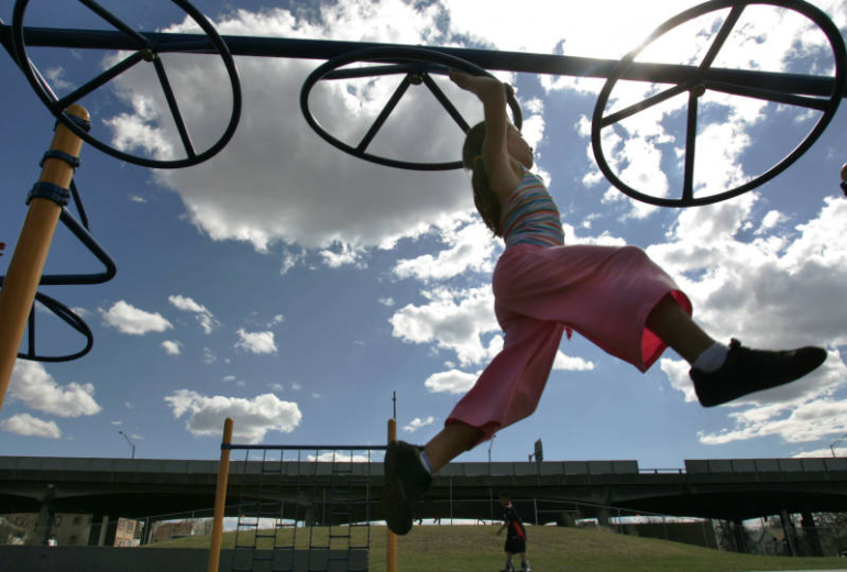 Emma Markovich, 5  plays on the monkey bars after a meeting held by the  newly-formed group, 'Mothers for Clean Air Colorado,'  at the Swansea Elementary School. Rocky Mountain News