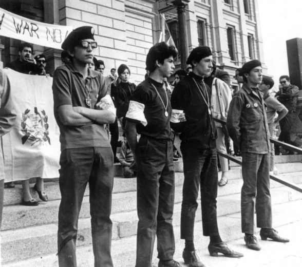 View of an antiwar demonstration in Denver, Colorado; shows Mexican-American men including "Corky" Gonzales (with banner).