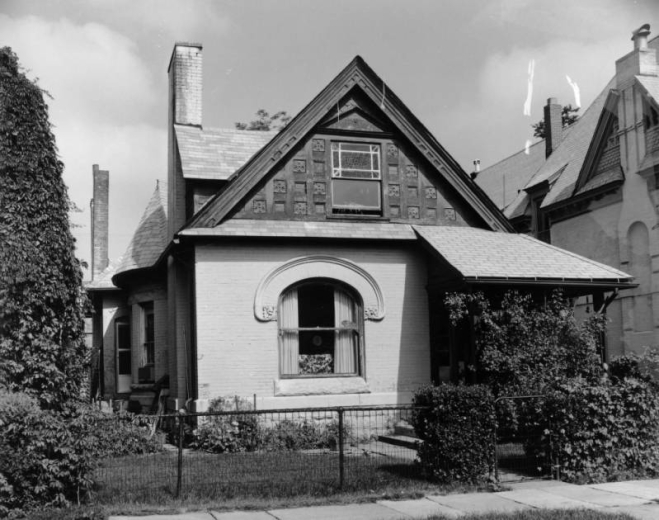 View of a house at 2521 Champa Street in the Five Points neighborhood of Denver, Colorado. The one-story brick house has a half turret and decorative window arch.