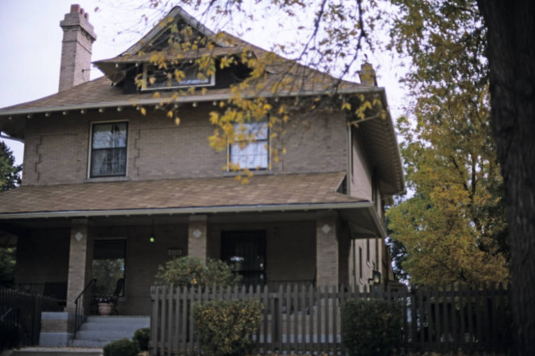 View of 4040 Montview Boulevard in the South Park Hill neighborhood, Denver, Colorado. This modified foursquare house (1910 : William E. Fisher) features a pedimented gable attic window, a covered porch and chimney.