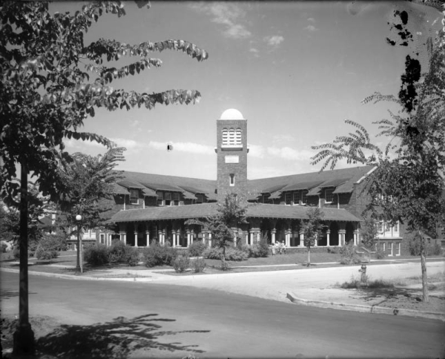 View of Washington Park Community Church at South Race and Arizona Streets in the Washington Park neighborhood in Denver, Colorado; features include a cloister and square tower.