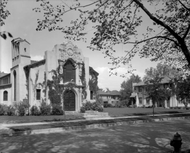 View of St. Thomas Episcopal Church at 22nd (Twenty-second) Avenue and Dexter Street in the South Park Hill neighborhood of Denver, Colorado; it has landscaping, a Mission style belfry, a tile roof, and a Churrigueresque portico.
