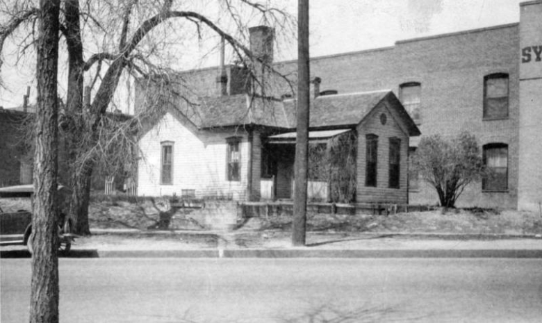 View of the Eugene Field house at 307 West Colfax Avenue in the Civic Center neighborhood of Denver, Colorado. The wood frame house has a hip roof and chimney.