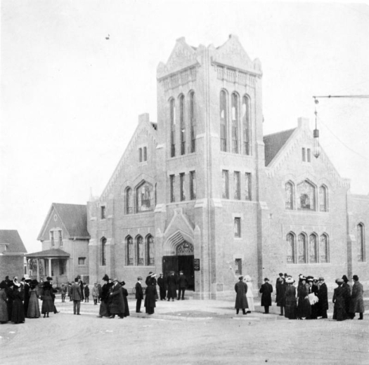 View of the Capitol Heights Presbyterian Church at 11th (Eleventh) Avenue and Fillmore Street in the Congress Park neighborhood of Denver, Colorado. The brick church has a tower and arched stained glass windows.