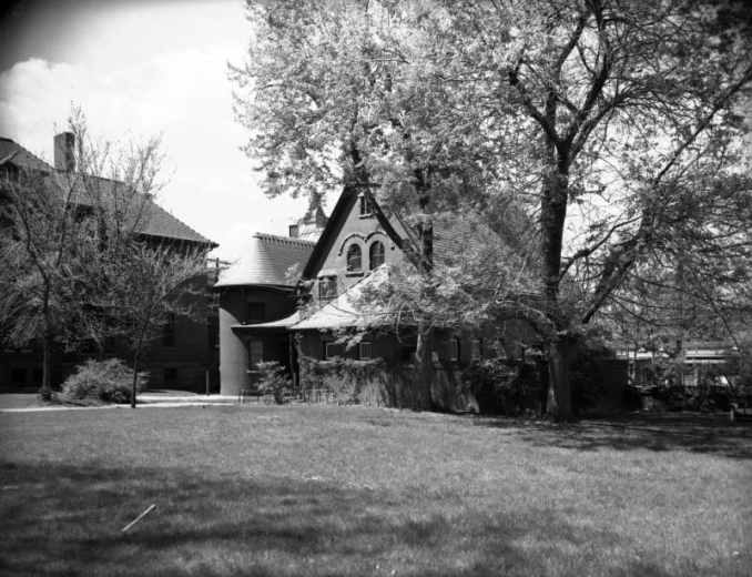 View of the Dennis Sheedy house at 11th (Eleventh) Avenue and Grant Street in the Capitol Hill neighborhood of Denver, Colorado. The Queen Anne style house has a turret with conical roof, a covered porch, and arched windows.