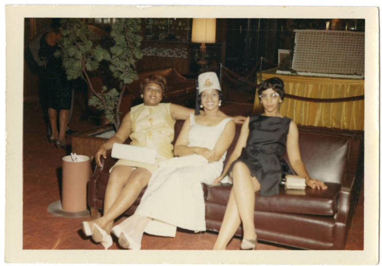 Photo of three ladies on brown couch