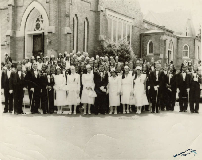 Exterior group photograph of Leroy Smith and other members of the Shriners Club Syrian Temple No. 49.
