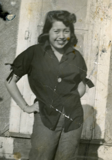Portrait of Magdalena Gallegos as a young woman, the local historian and author poses with her hands on her hips in the Auraria neighborhood, Denver, Colorado.