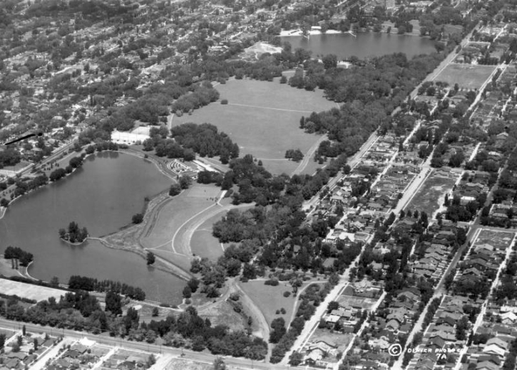 Aerial view of Washington Park. Visible is  Grasmere Lake, in the foreground, a large meadow, and Smith Lake. The neighborhood beyond the park is also visible.