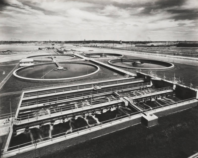 View of settling basins at the Metropolitan Denver Sewage Disposal District (now Metro Wastewater Reclamation District) plant, designed by architect Burnham Hoyt, at 50th (Fiftieth) Avenue and Emerson Street in Denver, Colorado.
