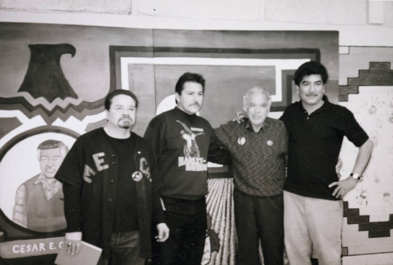 Activists, Ramon Del Castillo, Nick Vigil, Rodolpho "Corky" Gonzales and an unnamed man pose in from of a mural painted in honor of Cesar E. Chavez in Denver, Colorado.
