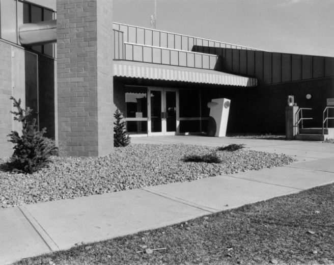 View of the Montbello Branch of the Denver Public Library in the Montbello neighborhood of Denver, Colorado; features irregular angles, an awning, and a metal roof.