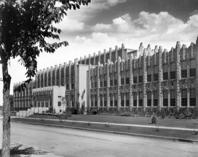 View of the Horace Mann Junior High School at 42nd (Forty-second) Avenue and Navajo Street in the Sunnyside neighborhood of Denver, Colorado. Shows spires with crockets and terra-cotta trim on a late Gothic style building. Features dense brick imbrication.