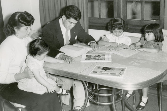 Rodolfo "Corky" Gonzales reads with his family