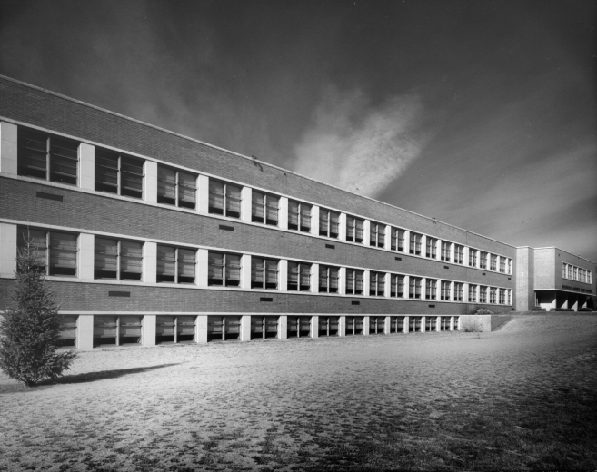 View of Merrill Junior High School (later Merrill Middle School) at East Florida and South Monroe streets  in the Cory-Merrill neighborhood of Denver, Colorado. Shows rows of windows on a three story building.