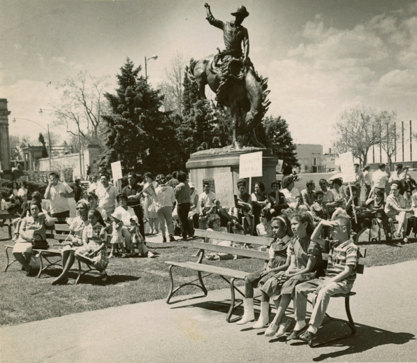 From back of photograph: Mexican music occupies the attention of Spanish-Americans and others at a political action rally of the "Crusade for Justice" in Civic Center. The rally, headed by Rudolph (Corky) Gonzales, also included voter registration at the Denver Election Commission, a sign-carrying march around City Hall, and a demonstration political caucus at the Denver Labor Center.