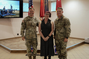 Keli Schmid is pictured with members of the current 10th Mountain Division 