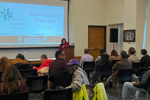 A picture of library officials speaking the community during the Blair-Caldwell Town Hall.