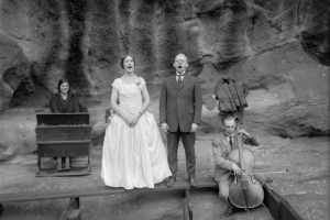Men and women sing, play a portable piano and cello at the Garden of Angels (Red Rocks Amphitheater) near Morrison (Jefferson County), Colorado.