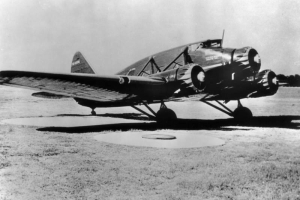 View of a three engine Stinson A passenger airplane with lettering: "[De]lta Airlines," and "U. S. Air Mail Route 2[?]."