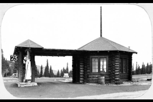 View of a fuel station at Echo Lake Park, part of the Denver Mountain Parks System (Clear Creek County), Colorado. The pumps are near an octagonal wood building. A sign reads: "23".
