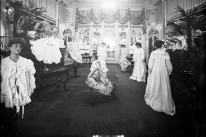 Interior view of the Daniels and Fisher store in Denver, Colorado; shows the "French Room," mannequins in lace and brocade gowns, mirrors and a plaster ceiling.