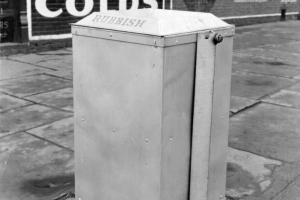 View of a trash can in Denver, Colorado; letters read: "Rubbish." Advertisements read: "Balsam for Colds," and "Cordove Cigar Co."
