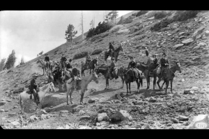 View of Pikes Peak trail at timberline with a group of men and women on horseback, El Paso County, Colorado.