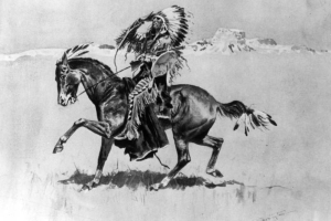 A Native American (Cheyenne) man on horseback holds a rifle and wears moccasins, fringed leggings and shirt, and a feather headdress.