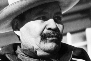 Portrait of a Mexican migrant worker in Colorado. He wears a wide-brimmed hat and jacket with a pin that reads: "CIO."