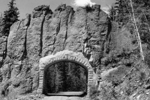 View of a stone arch and tunnel built through a volcanic dike on the Cordova Pass (Apishapa Pass) road in Las Animas County, Colorado.