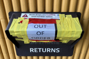 Ford-Warren Branch Library taped shut book drop during Denver's COVID-19 stay-at-home order. There is a sign on the book drop, that reads:  "OUT OF ORDER". There is also a sticker that reads:  "Book drops are CLOSED until further notice. While we are closed due dates will be extended. For updates visit, denverlibrary.org."