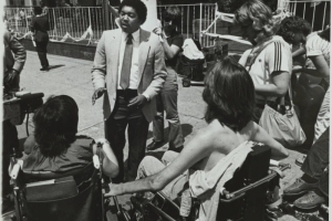 McDonald's official Dennis Morris talks with spokespersons for a group of protestors that use wheelchairs. The protestors are blocking entrances to the McDonald's located on Colfax Avenue and Pennsylvania Street demanding wheelchair access so that the experience of indoor dining can be available to all patrons (universal design) and accessible to people with disabilities (barrier-free design). 