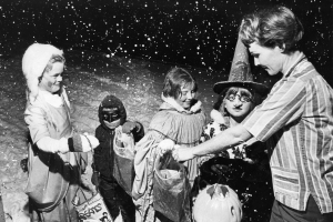 Goblins given a warm reception by Mrs. Robert Fiori. October 31, 1966. Photo by Mel Schieltz. Rocky Mountain News Photograph Collection