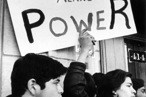 Young Mexican-American men protest the arrest of Mexican Americans for a bus bombing in Denver, Colorado. They hold a sign that reads: &quot;Chicano Means Power.&quot;