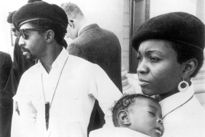 Mr. and Mrs. Joseph Sullivan, African Americans and members of the Black Panther Party, pose in Denver, Colorado. They wear berets and hold a baby.