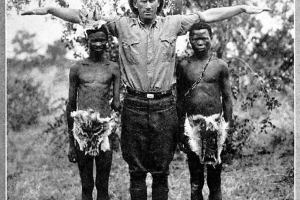 "Dr. Cadle and two average size Kalahari Bushmen"