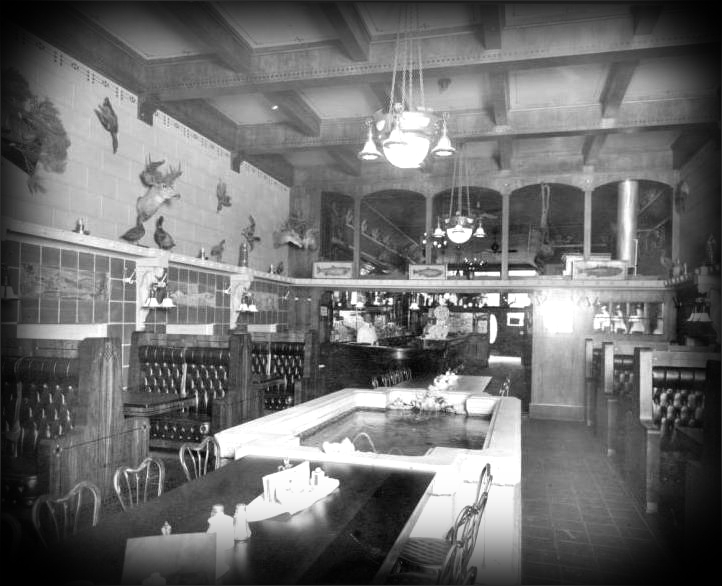 Interior view of the Watrous Cafe in Denver, Colorado; decor includes a fountain / trout pool, a coffered ceiling, stenciled ornaments, hanging lamps, tuck and roll upholstery, painted ceramic tiles, and taxidermic mounted animal heads, fowl, and fish. 